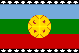 The Mapuche flag, Wenufoye, representing Mapuche cosmology. It has three horizontal stripes: blue for the sky and spirituality, green for the earth, and red for historical struggle. Centered is the yellow kultrun, a ceremonial drum symbol representing the cosmos, with its four quarters marking the cardinal directions. A gemil (stepped cross) pattern along the top and bottom symbolizes traditional knowledge.