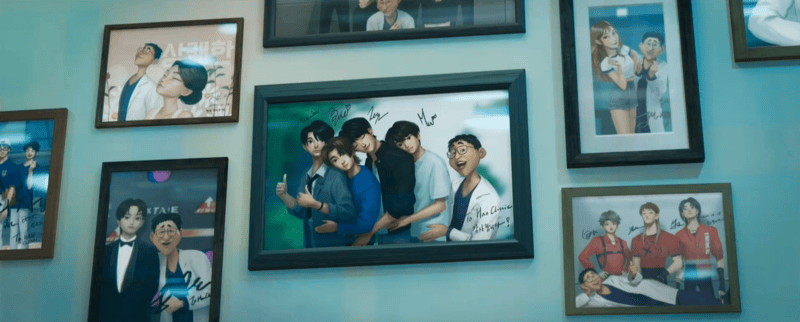 Wall of fake photos of Dr. Han with idols from the movie KPop Demon Hunters